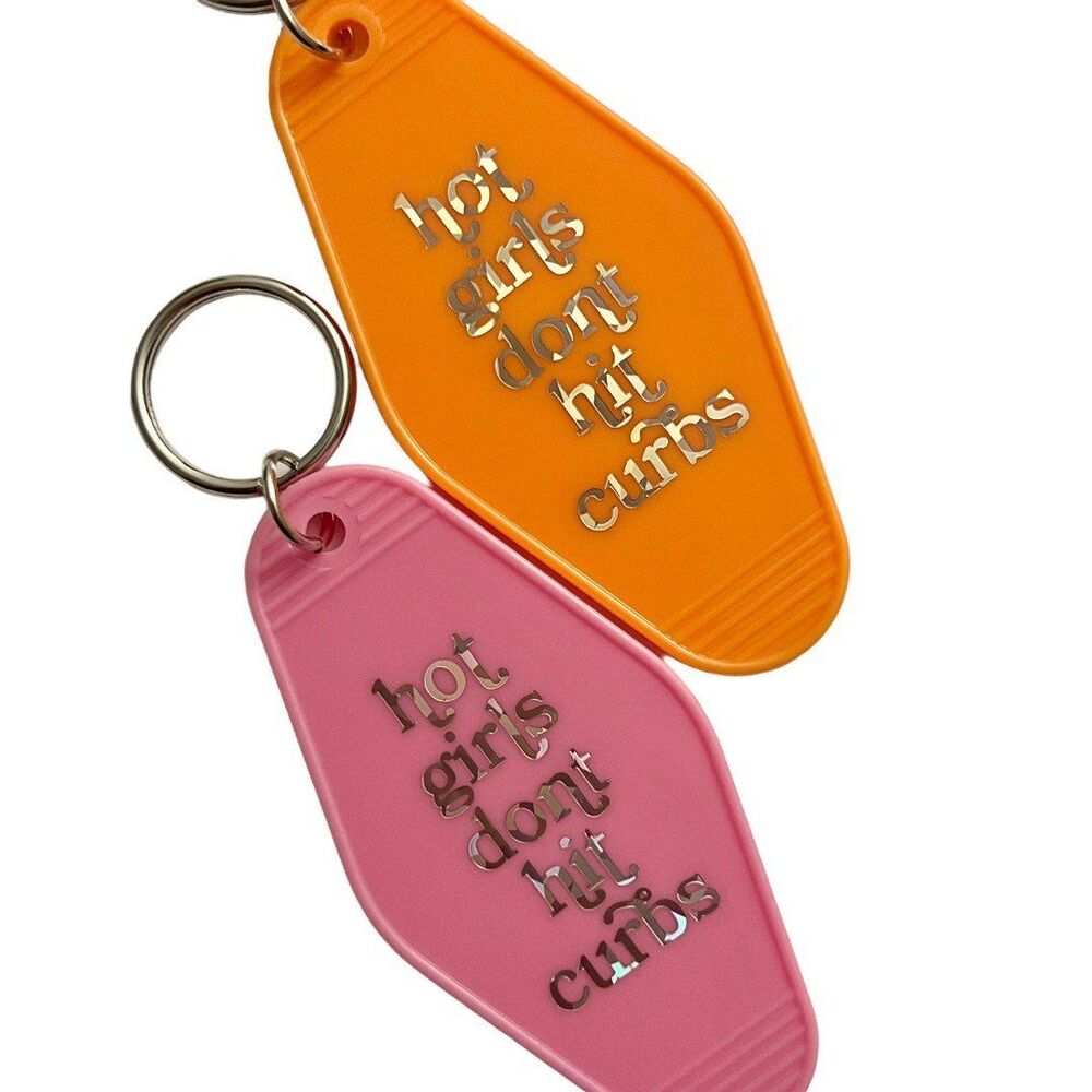 Orange Motel Room Keychain Holographic print says “hot girls don’t hit curbs”